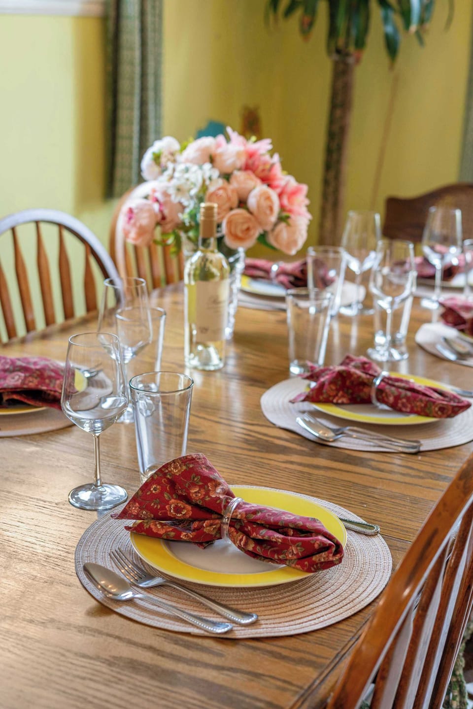 Elegantly Set Dining Table with Wine Glasses and Floral Centerpiece