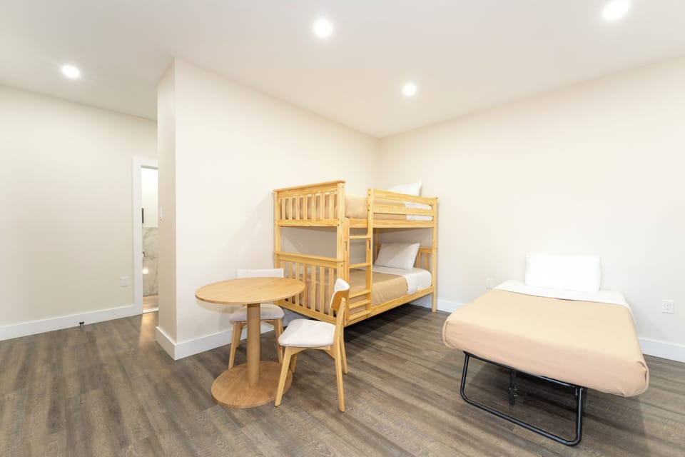 A bright, versatile bedroom ready for your whole group, with sturdy bunk beds and a flexible sleeping setup for comfort and convenience.