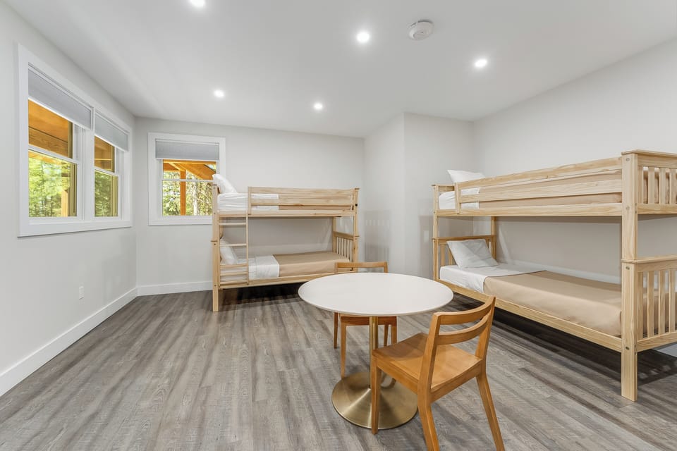 Your bright, airy bunk room offers comfortable sleeping for the whole group, with natural wood bunks and a charming table where the kids can play games or enjoy morning cocoa together.