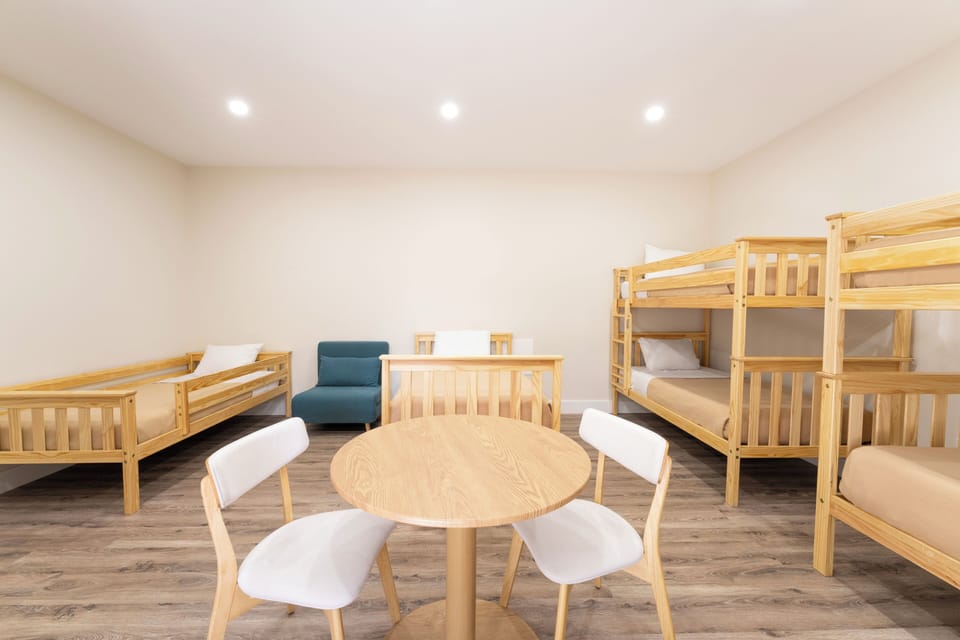 Spacious bunk room with cozy sleeping arrangements and a welcoming seating area—perfect for gathering with family or friends.