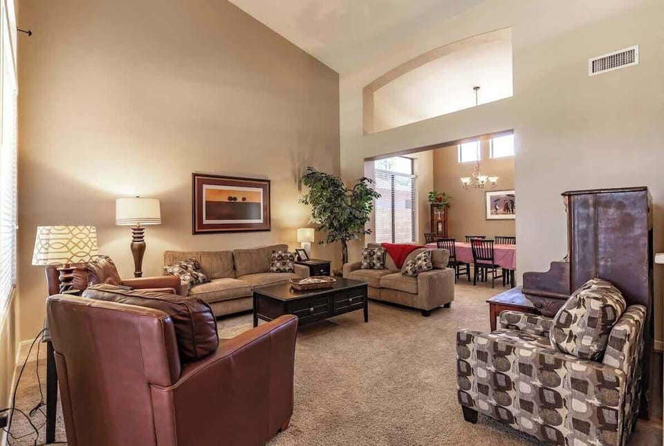 High ceilings and lots of great seating fill this cozy front sitting room.
