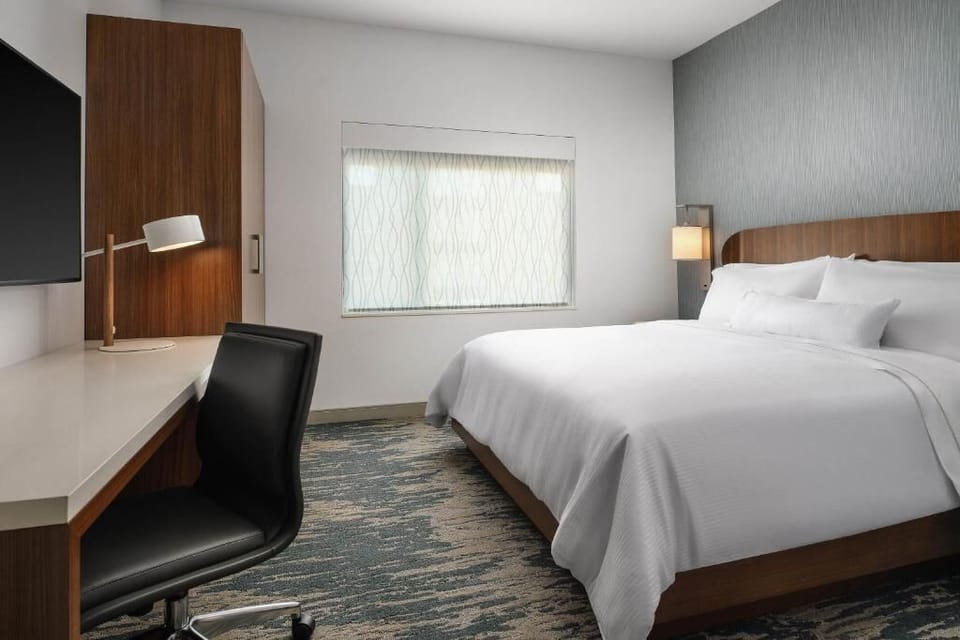 Recharge in a calming king bed with crisp linens.