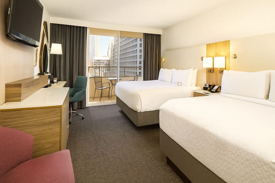 Wake up to bright city views from plush double beds.