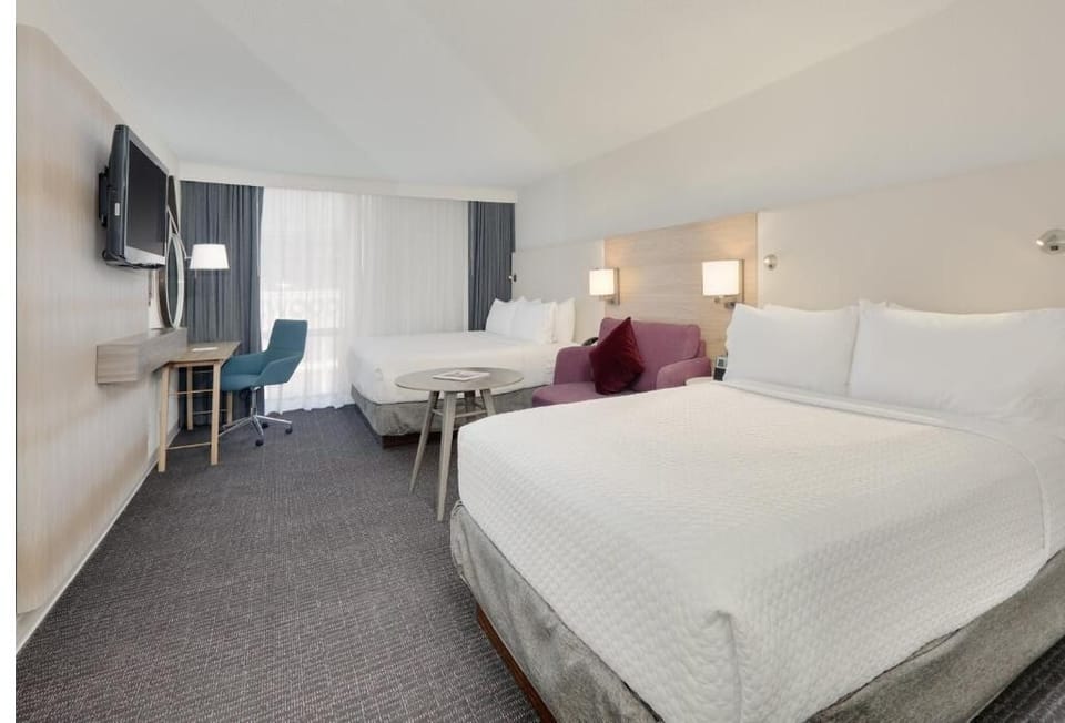 Unwind on the cozy loveseat between crisp, cloud-soft beds.
