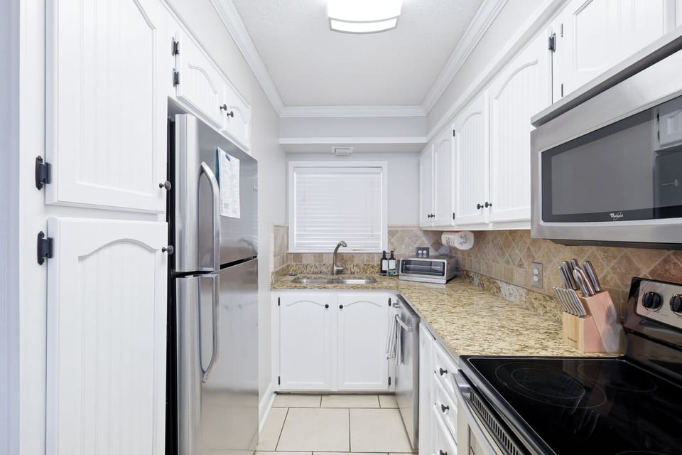 Bright updated kitchen with granite counters and stainless appliances