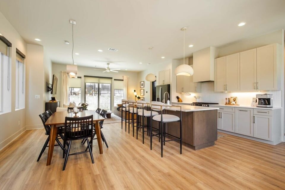 Modern kitchen with large island and open flow into living and dining areas