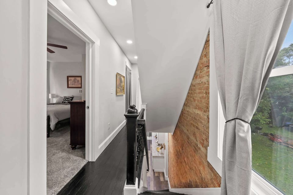 Breeze through the airy hallway, curtains fluttering in the natural light.