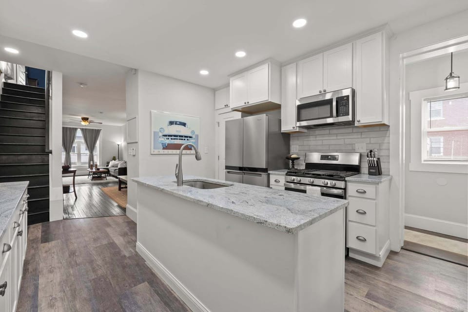 Move freely through the open, airy kitchen w/ stainless fridge & island.