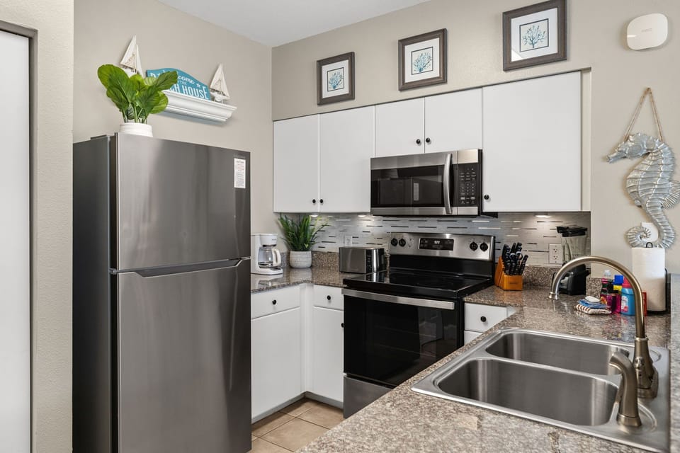 Fully stocked kitchen with brand-new stainless-steel appliances, granite countertops, and everything you need for easy meals during your stay.