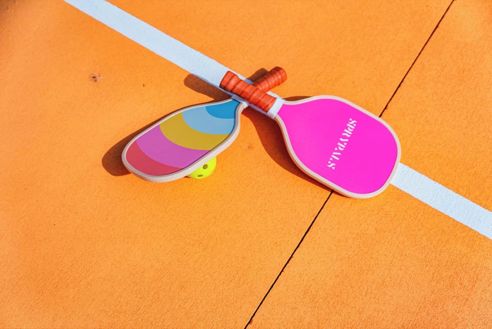 Activity Zone: Dive into fun with vibrant paddles and a sunny court ready for action!