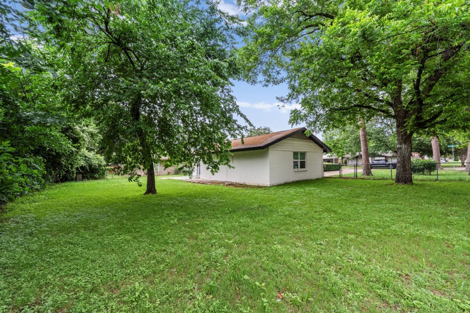 Fully fenced backyard with plenty of green space—perfect for relaxing, pets, or enjoying the outdoors in privacy.