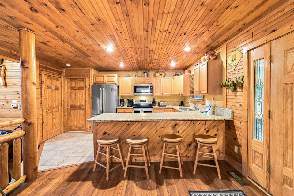 Rustic cabin kitchen with granite bar seating for 4 and stainless appliances