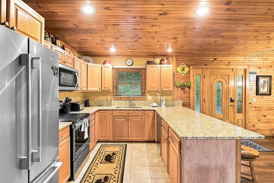 Cozy cabin kitchen with granite counters and roomy breakfast bar