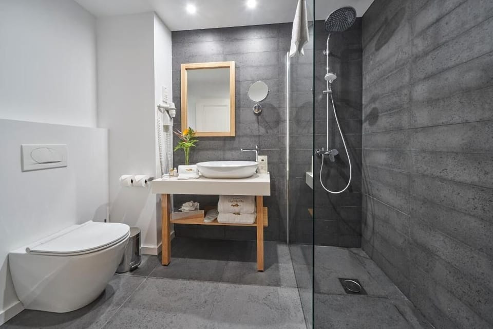 Refresh under the rainfall shower in a sleek modern bath.