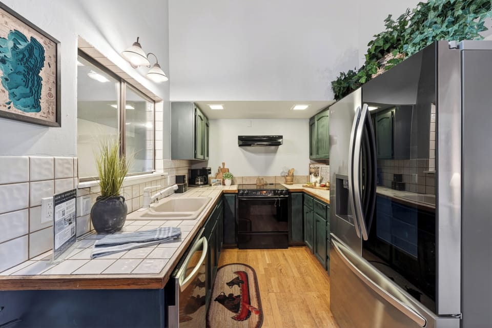 Fully equipped kitchen with stainless steel appliances and ample counter space.