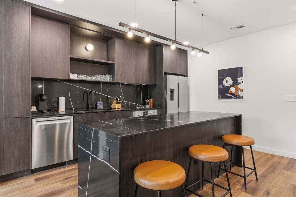 Barstool seating at the kitchen island. (Unit 209)