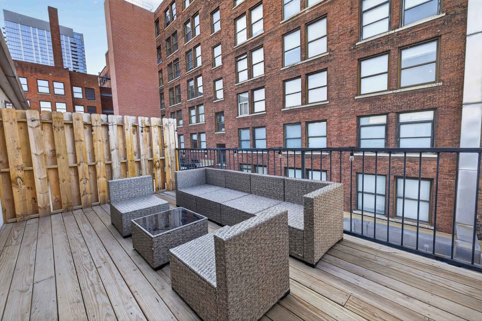 Private rooftop patio w/ outdoor seating & surrounding city views for relaxing evenings