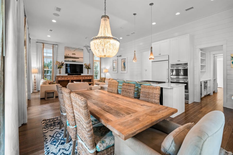 The open kitchen and dining area offer space to enjoy meals at the house or your favorite games at the oversized table. 