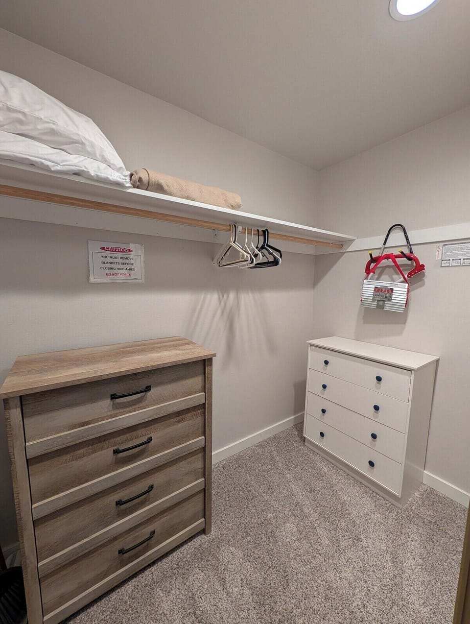 Large closet space with ample clothing storage. Includes extra linens, iron, ironing board, and vacuum.