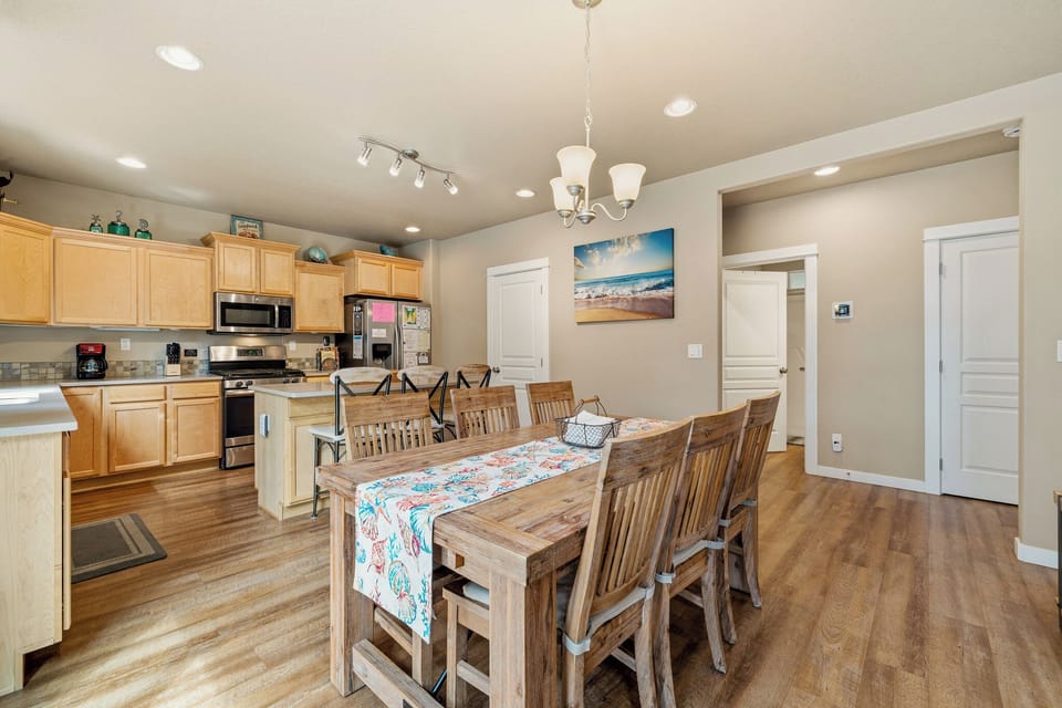Gather around this spacious dining table that seats eight, just steps from your fully equipped kitchen where you can prepare and serve meals with ease during your stay.