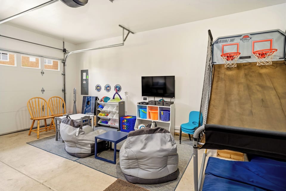 Your kids will love this fun-filled game room with basketball hoops, cozy bean bags, and a TV for movie nights—perfect for family entertainment.