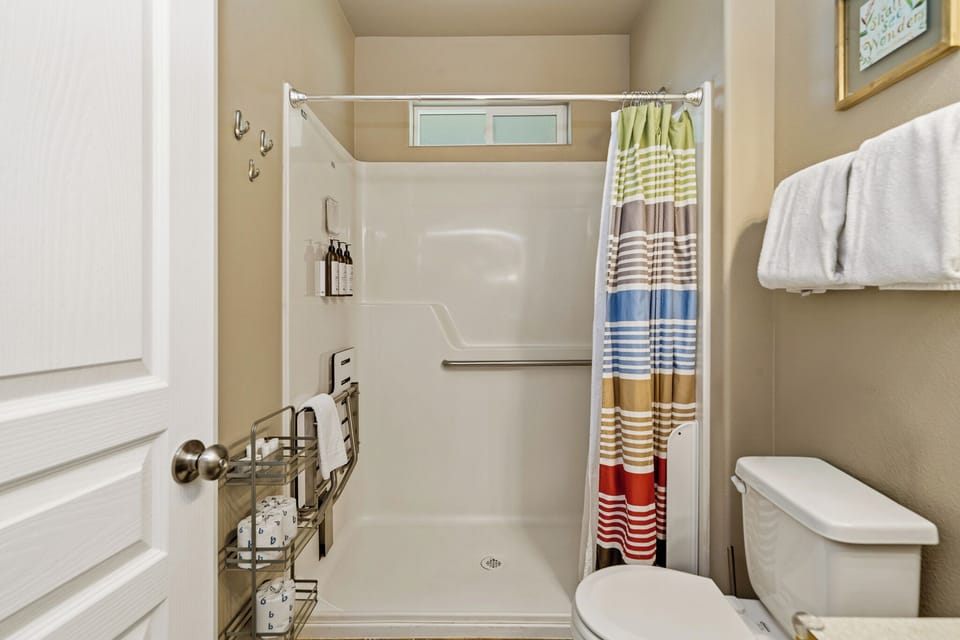 Refresh yourself in this sparkling walk-in shower, complete with built-in seating, thoughtful storage, and soft towels ready for your arrival.