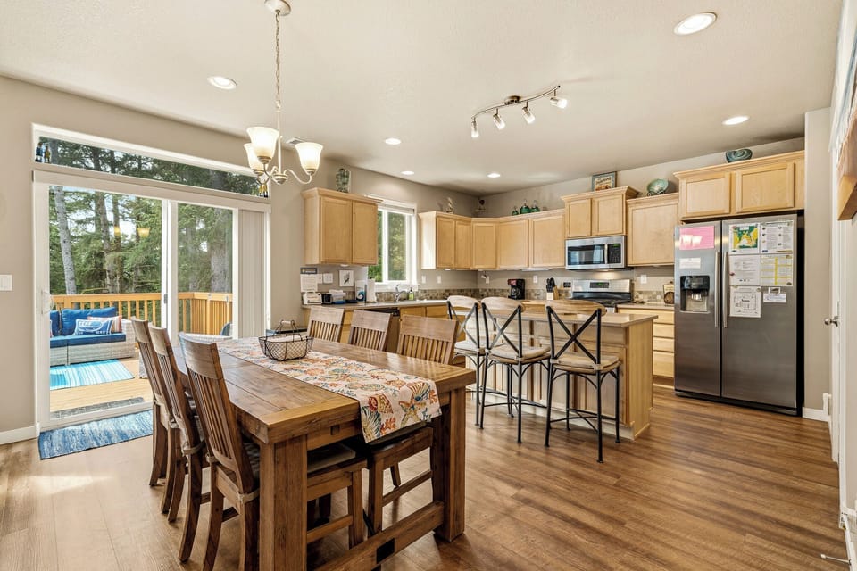 Your fully equipped kitchen and dining space flows seamlessly to a sun-drenched deck, perfect for morning coffee or outdoor meals with loved ones.