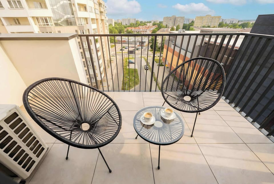 Spacious balcony with outdoor seating, ideal for relaxing and enjoying fresh air.