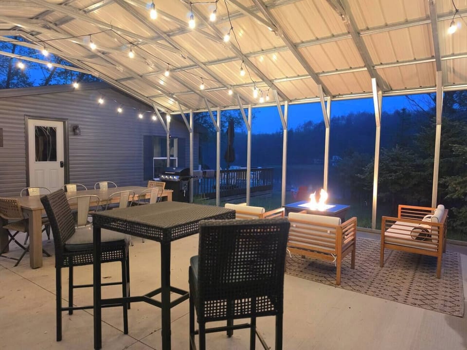 Our favorite evening spot—unwind under the string lights by the glowing fire table.