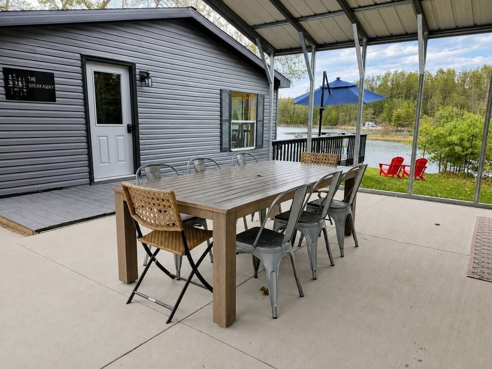 The massive outdoor dining table is fully covered, providing a weatherproof space for large group meals and board games. Space for 10, plus a 2 top bistro table.