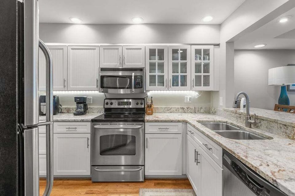 Well appointed kitchen with under cabinet lighting and stainless steel appliances.