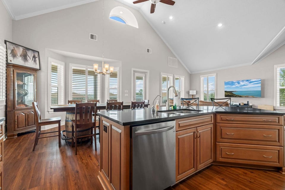 Cook, dine, and unwind in this bright open-concept space with vaulted ceilings and a spacious chef-style kitchen.