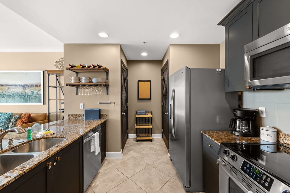 The fully equipped kitchen features granite countertops, stainless-steel appliances, and has everything you need to prepare meals for family & friends.