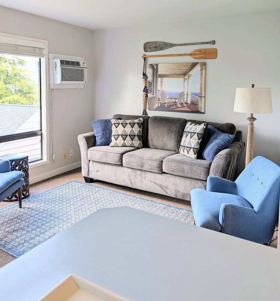 Memory foam mattress sofa bed sleeps two in living room.