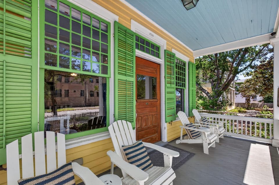 Colorful, comfy porch with Adirondack chairs on a quiet street