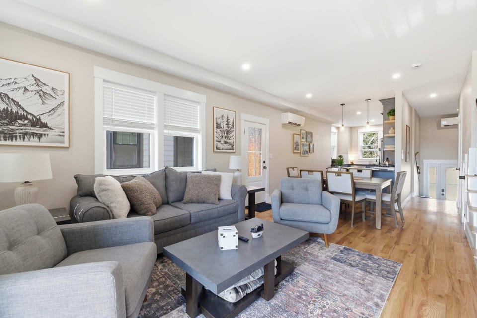 The main living level flows from the living area straight through to the dining table and kitchen — open, easy, and built for groups.