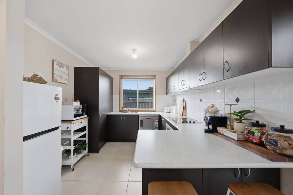 Fully equipped kitchen with modern appliances and ample bench space
