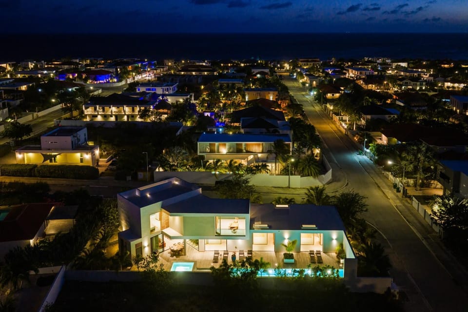 Villa Larga illuminated after dark, creating a peaceful setting for evenings by the pool.