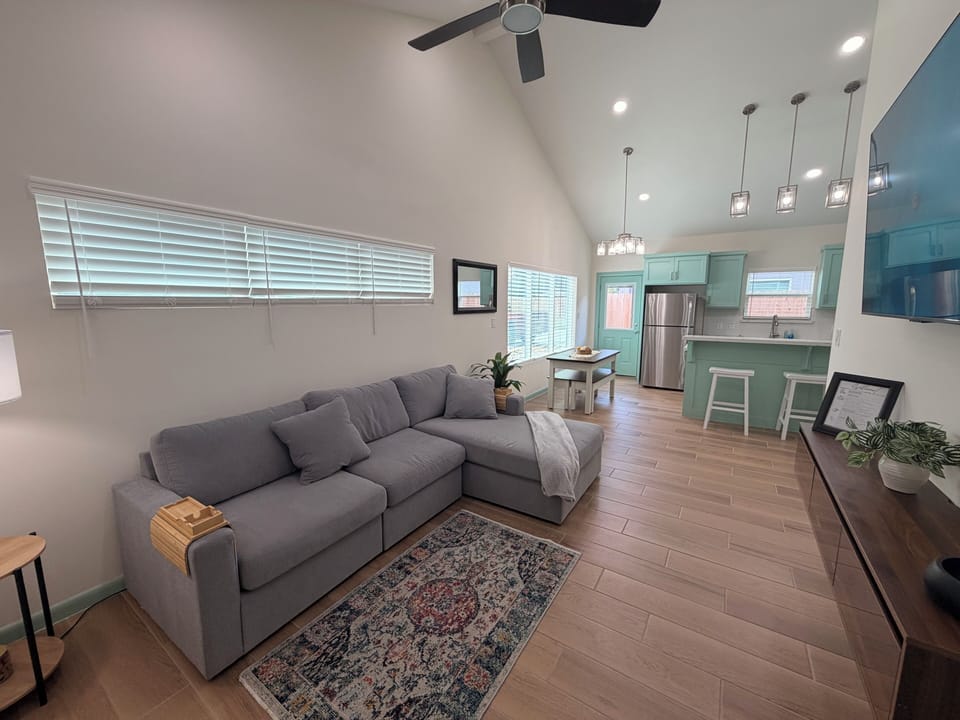 Bright open living space with vaulted ceilings and a stylish modern kitchen
