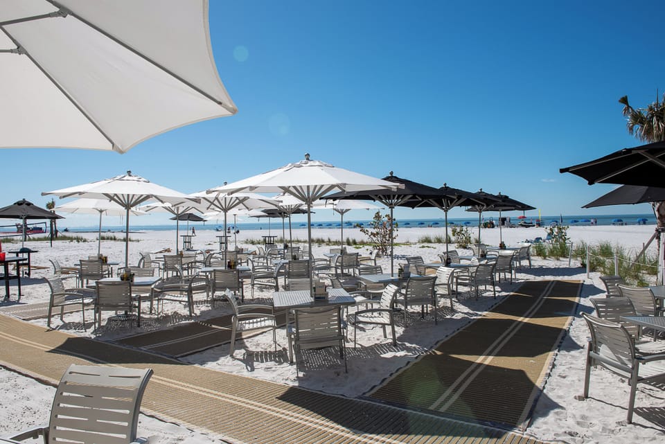 Arrive to a beachfront high‑rise with resort amenities below.