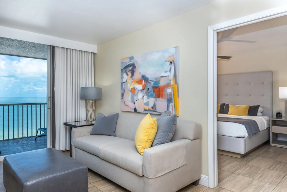 Step into a cozy suite where bedroom meets ocean breeze.