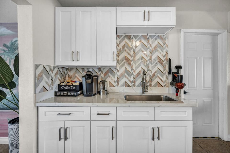 Start your mornings your way with a fully equipped coffee station featuring a Keurig, drip coffee maker, coffee pods, tea variety, cream, and sugars - everything ready for an easy, cozy start to the day.