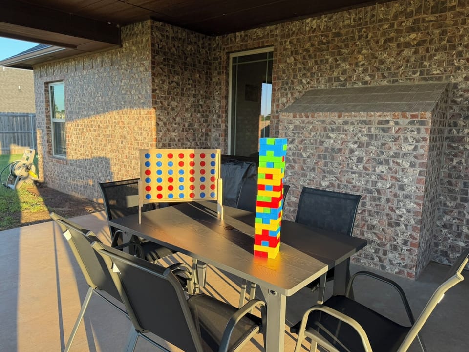 Covered patio with outdoor dining and fun oversized games for guests
