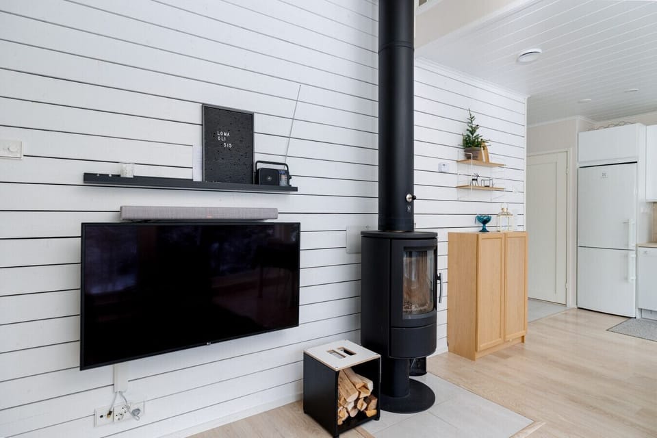 Enjoy a premium media experience with our wall-mounted smart TV and sleek soundbar, perfect for streaming your favorite music or movies. The integrated shelving also provides space for your personal items, keeping the living room organized during your sta