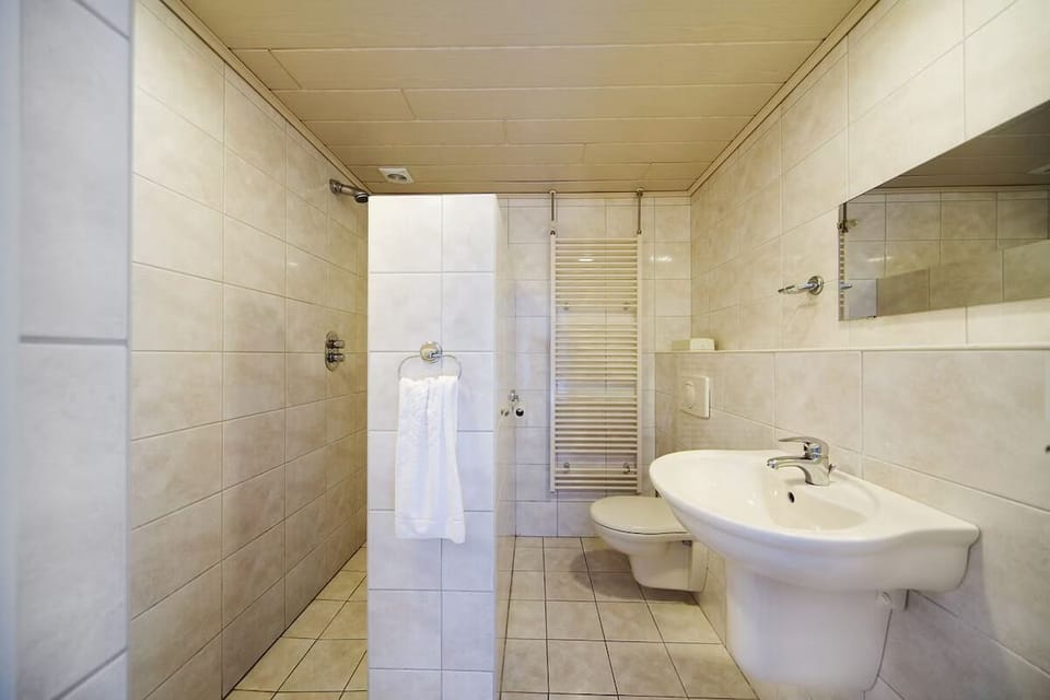 Refresh easily in the spacious bathroom with bright vanity.