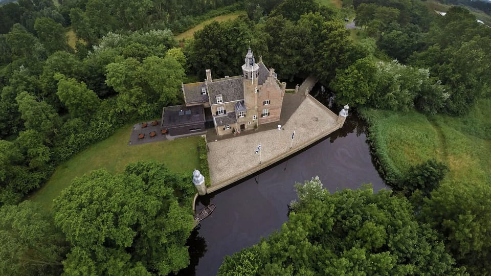 Escape to a fairytale castle surrounded by tranquil forested waters.