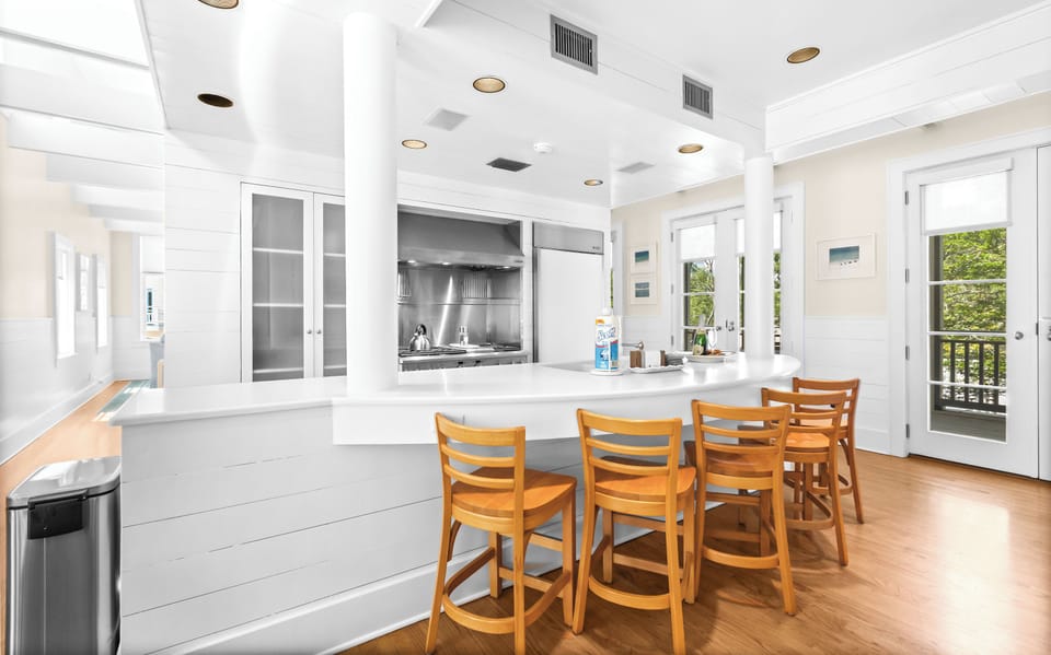 Gather around the bright breakfast bar in your open-concept kitchen, where stainless steel appliances and warm wooden floors create a welcoming space for morning coffee and conversation.