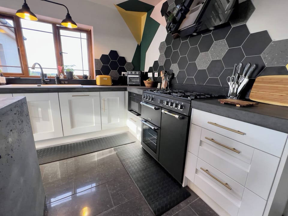 Gas range with electric ovens
