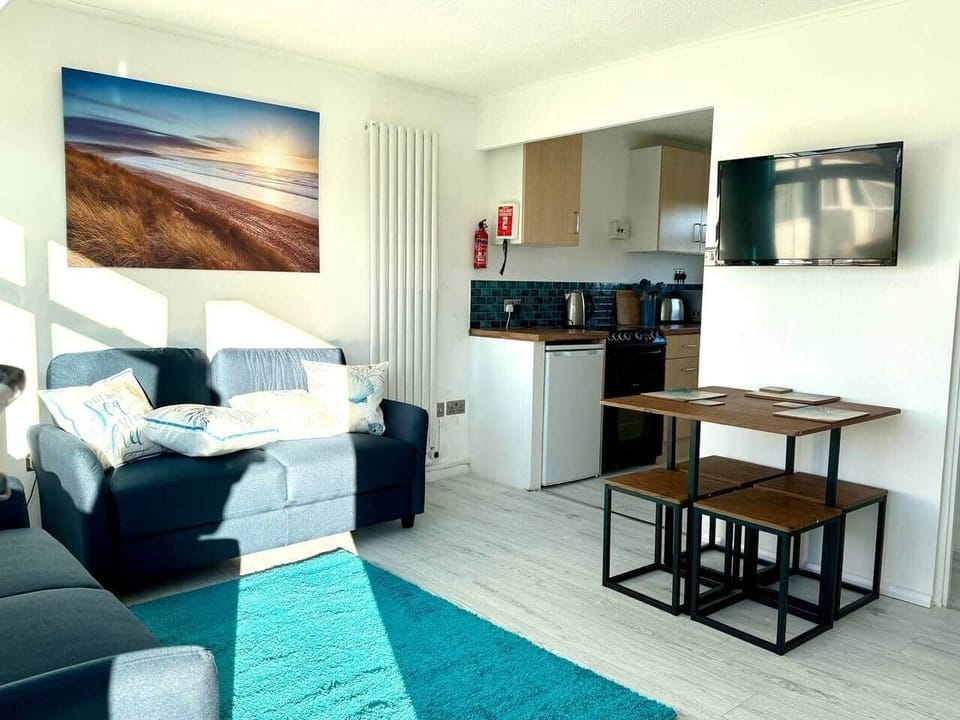 Modern open-plan living area with Smart TV and comfortable seating