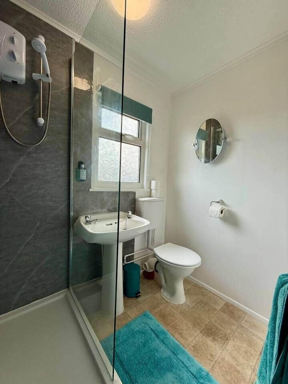 Clean and modern bathroom with shower, sink and WC
